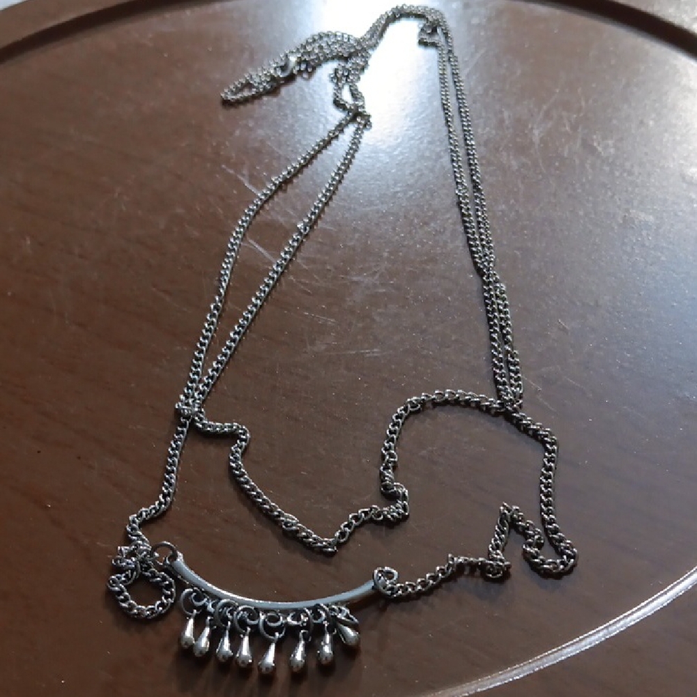 Elegant Silver Necklace with Dangling Charms